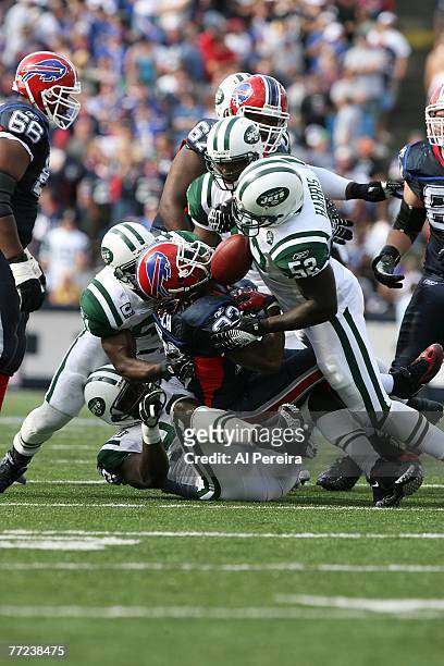 Linebacker David Harris of the New York Jets jars the ball loose from Running Back Marshawn Lynch of the Buffalo Bills at Ralph Wilson Stadium,...