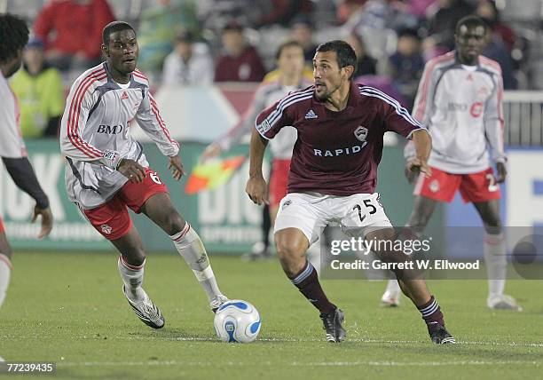 Pablo Mastroeni of the Colorado Rapids fights for the ball against Maurice Edu of the Toronto FC at Dick's Sporting Goods Park on October 7, 2007 in...