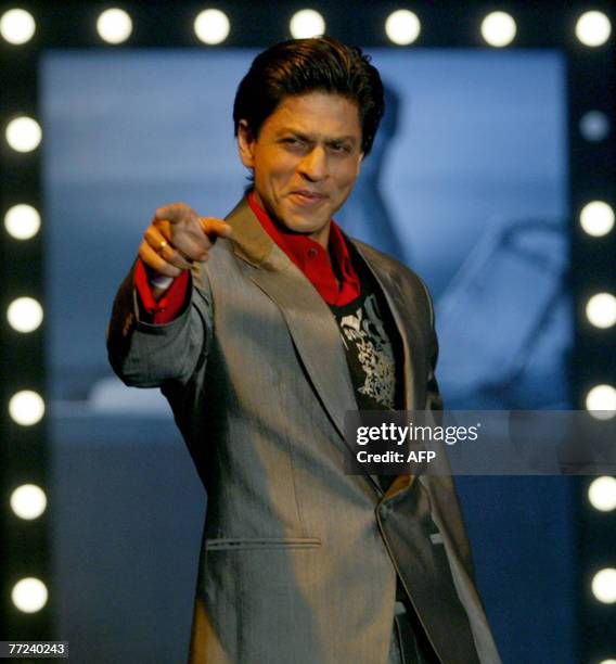 Indian Bollywood actor Shahrukh Khan gestures on the catwalk as he presents outfits at the Shopper stop's Om Shanti Om collection at a Mumbai hotel,...