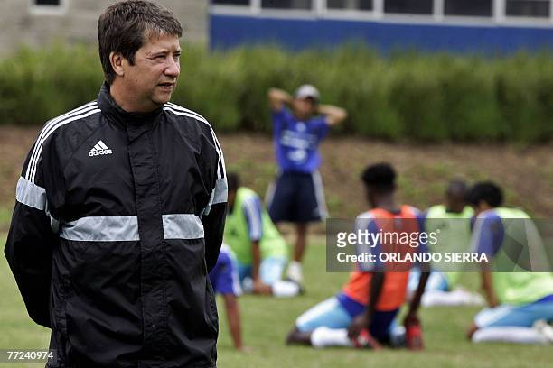 The coach of the Guatemalan national team, Colombian Hernan Dario "El Bolillo" Gomez, looks at his players during a training session in Guatemala...