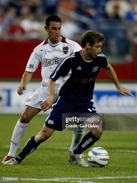 New England Revolution Steve Ralston, front, tries to keep the ball away from MetroStars, Mark Lisi, left, Saturday, June 25, 2005 at Gillette...