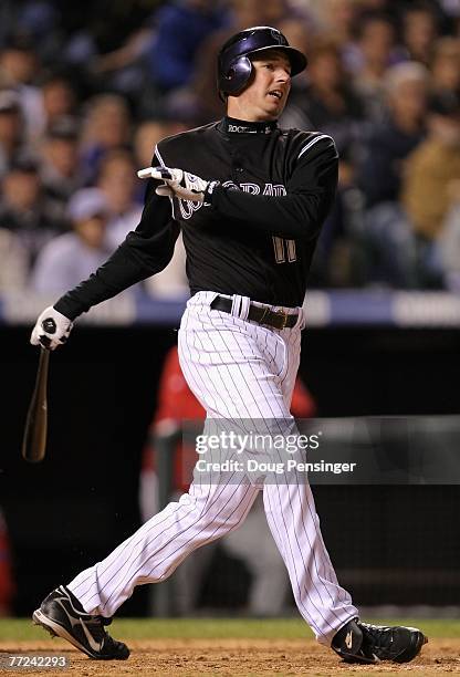 Brad Hawpe of the Colorado Rockies hits a single against the Philadelphia Phillies in Game Three of the National League Divisional Series at Coors...