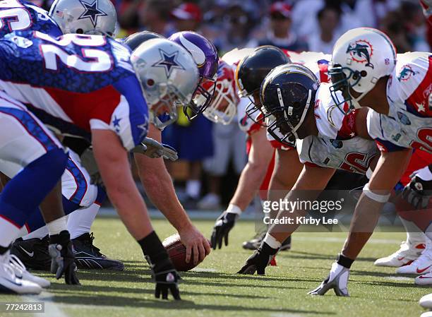 Center Matt Birk of the Minnesota Vikings squares off with AFC defensive tackle Jamal Williams at the line of scrimmage during the NFL Pro Bowl at...