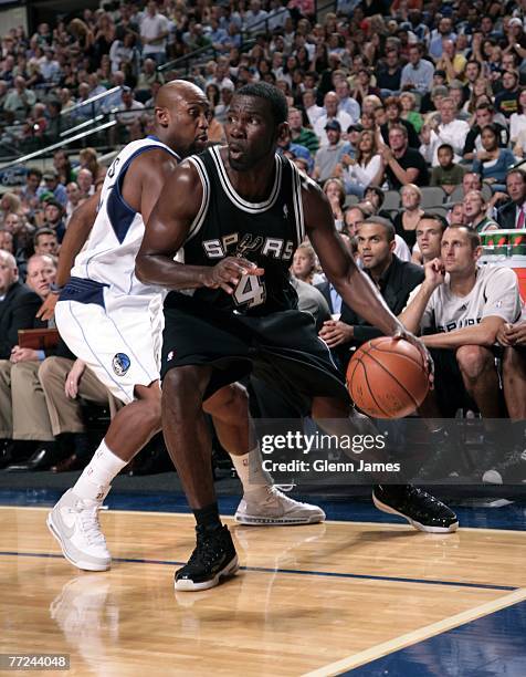 Michael Finley of the San Antonio Spurs drives baseline on Trenton Hassell of the Dallas Mavericks on October 9, 2007 at the American Airlines Center...