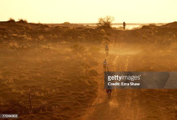 Riders ride and walk up a sand dune during the first stage on day one of the Simpson Desert Bike Challenge race on October 2, 2007 in the Simpson...