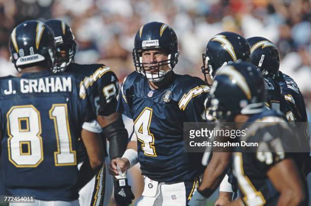 Jim Harbaugh, Quarterback for the San Diego Chargers talks to his offensive line in the huddle during the American Football Conference West game...