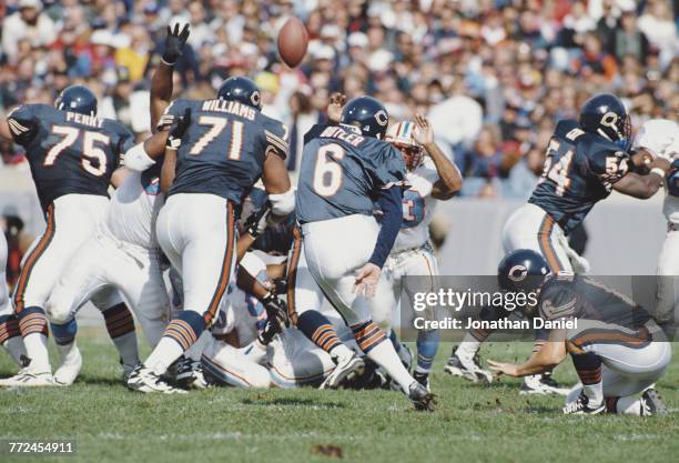 Place kicker Todd Sauerbrun looks on as Kevin Butler, Kicker for the Chicago Bears kicks a field goal during the National Football Conference Central...