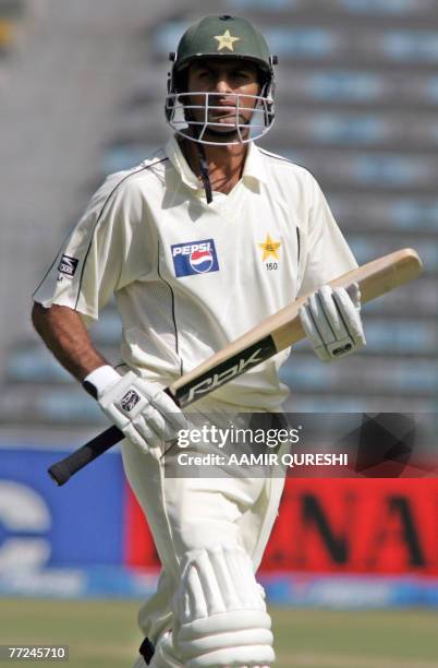 Pakistani cricket team captain Shoaib Malik walks back to pavilion after his dismissal during the third day of the second Test match between Pakistan...