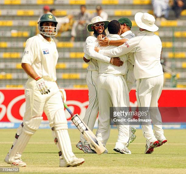 Makhaya Ntini, Hashim Amla, Ashwell Prince and AB de Villiers celebrate the wicket of Misbah-ul-Haq during day three of the second test match series...
