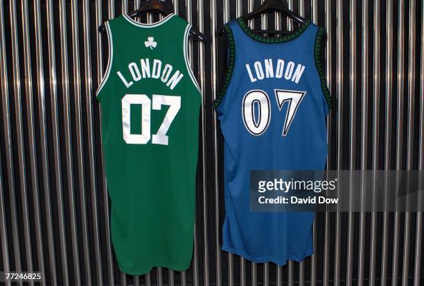 Boston Celtics & Minnesota Timberwolves official London NBA basketball uniforms hang on display during a press conference for NBA Commissioner David...