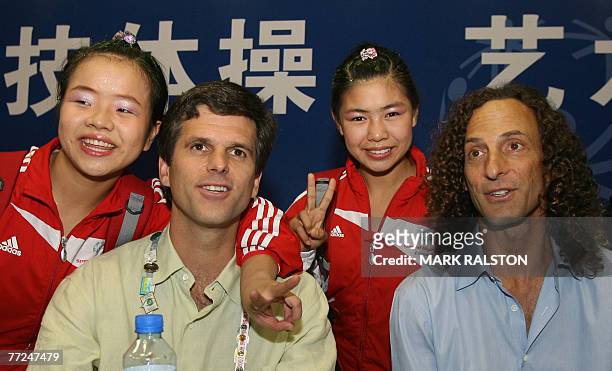 The Chairman of the Special Olympics, Timothy P. Shriver and musician Kenny G pose with Chinese gymnasts Xing Le and Zhu Ting at the gymnastic events...