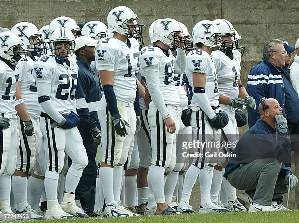 Yale University head football coach Jack Siediecki, right, and part of his team watch the closing moments of the Harvard Yale football game, famously...