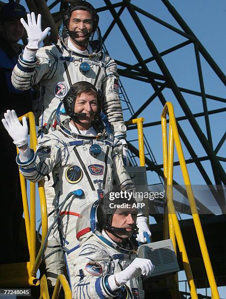 Members of an International space crew Sheikh Muszaphar Shukor of Malaysia, Yury Malenchenko of Russia and US Peggy Whitson wave just before boarding...