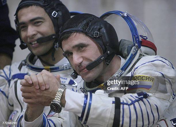 Members of an International space crew Sheikh Muszaphar Shukor of Malaysia and Yury Malenchenko of Russia wave during a farewell ceremony at the...