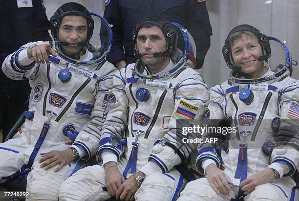 Members of an International space crew Sheikh Muszaphar Shukor of Malaysia, Yury Malenchenko of Russia and US Peggy Whitson wave during a farewell...