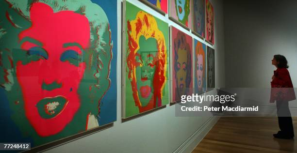 Visitor to the Pop Art Portraits exhibition at National Portrait Gallery looks at Andy Warhol's 'Marilyn Monroe 1967' on October 10, 2007 in London....