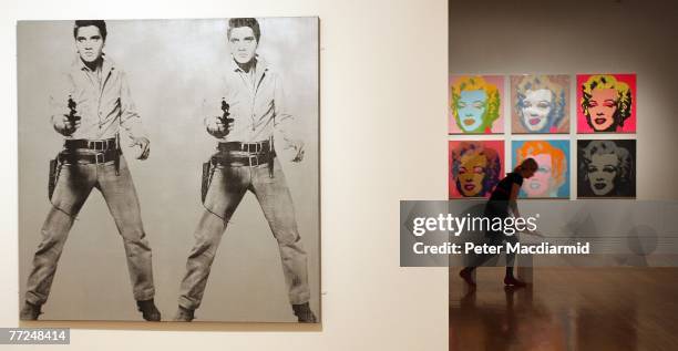 Andy Warhol's 'Double Elvis 1963' and 'Marilyn Monroe 1967' are displayed at the Pop Art Portraits exhibition at National Portrait Gallery on October...