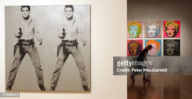 Andy Warhol's 'Double Elvis 1963' and 'Marilyn Monroe 1967' are displayed at the Pop Art Portraits exhibition at National Portrait Gallery on October...