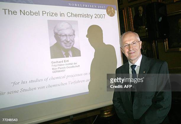 Gunnar Oquist chairman of the Royal Swedish Academy of Sciences poses 10 October 2007 in front of a screen, showing German Gerhard Ertl who won the...