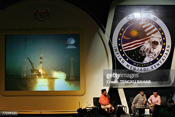 Malaysian Prime Minister Abdullah Ahmad Badawi and Deputy Prime Minister Najib Razak watch a live telecast beamed from the Baikonur Cosmodrome in...