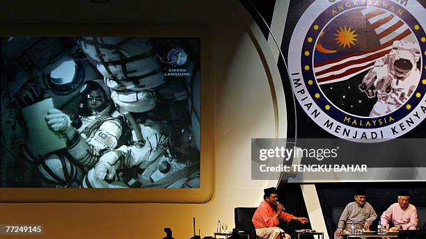 Malaysian Prime Minister Abdullah Ahmad Badawi and Deputy Prime Minister Najib Razak watch a live telecast of Malaysia's first astronaut Sheikh...