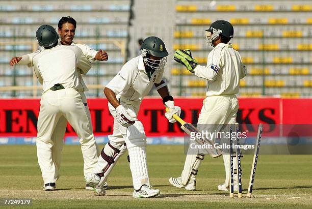 Abdul Rehman and Misbah-ul-Haq celebrate the wicket of Hashim Amla during day three of the second test match series between Pakistan and South Africa...