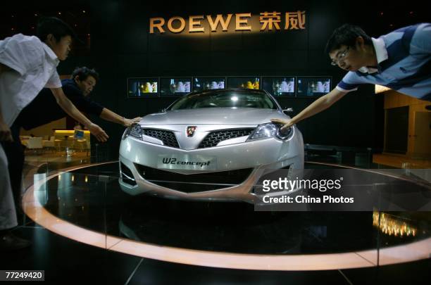Visitors view a Roewe 750 sedan at the Nanjing International Auto Expo on October 9, 2007 in Nanjing of Jiangsu Province, China. The expo, scheduled...