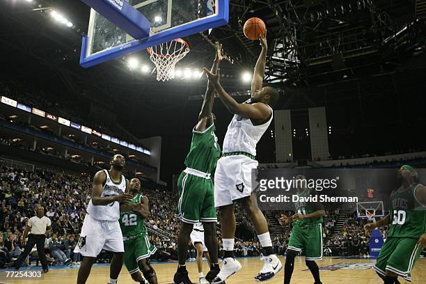 Craig Smith of the Minnesota Timberwolves goes to the basket against Kevin Garnett of the Boston Celtics in the O2 Arena in London during NBA Europe...