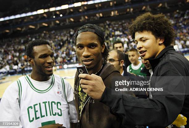 Chelsea footballer Didier Drogba is surrounded by fans at halftime during the basketball game between The Minnesota Timberwolves and the Boston...