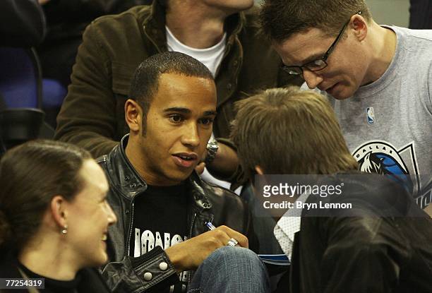 British Formula One driver, Lewis Hamilton signs autographs for fans during NBA Europe Live 2007 Tour match between the Boston Celtics and the...