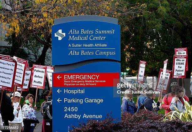 Registered nurses carry signs as they demonstrate outside of Alta Bates Medical Center October 10, 2007 in Berkeley, California. An estimated 5,000...