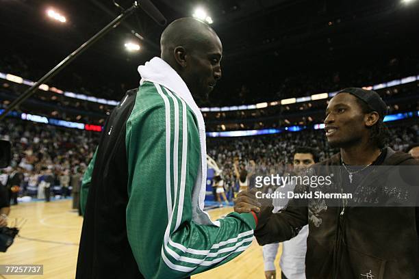 Kevin Garnett of the Boston Celtics greets Didier Drogba, Footballer for The Chelsea Football Club, after a preseason game against the Minnesota...