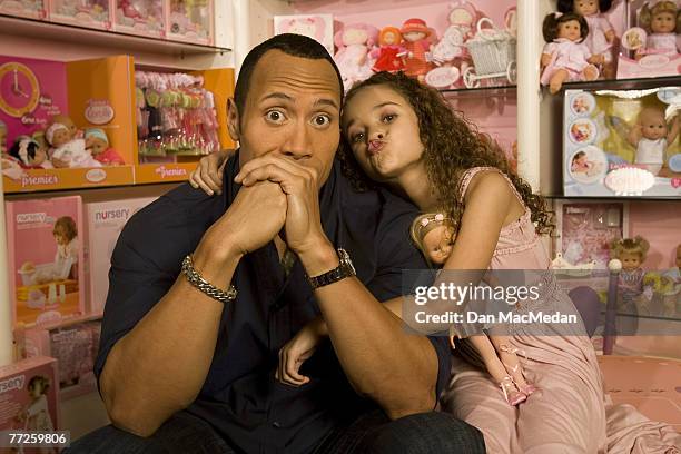 Actor and former pro wrestler Dwayne "The Rock" Johnson and actress Madison Petis pose at a portrait session at the Toyology toy showroom in Los...