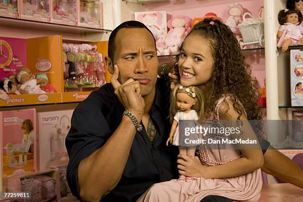 Actor and former pro wrestler Dwayne "The Rock" Johnson and actress Madison Petis pose at a portrait session at the Toyology toy showroom in Los...