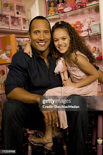 Actor and former pro wrestler Dwayne "The Rock" Johnson and actress Madison Petis pose at a portrait session at the Toyology toy showroom in Los...