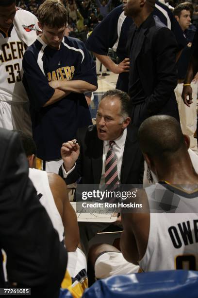 Head coach Jim O'Brien of the Indiana Pacers goes over plays during a time-out during preseason action against the New Orleans Hornets at Conseco...