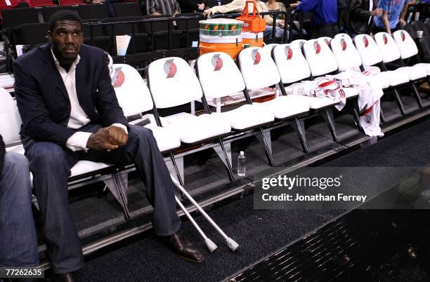 Greg Oden of the Portland Trail Blazers, who is out for the season after under going micro fracture surgery in his knee, sits on the bench to watch a...
