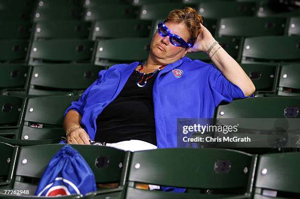 Fan of the Chicago Cubs sits in the stands dejected after the Cubs lost 5-1 against the Arizona Diamondbacks during Game Three of the National League...