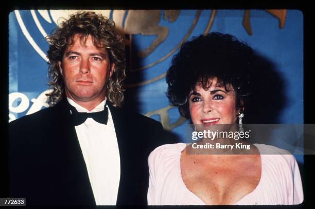 Elizabeth Taylor stands with boyfriend Larry Fortensky October 26, 1990 in Los Angeles, CA. The Carousel of Hope has been the world's premier...