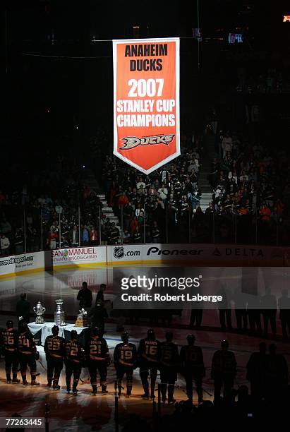 The 2007 Stanley Cup Champions banner is lifted to the rafters of the Honda Center as the Anaheim Ducks look on before their game against the Boston...
