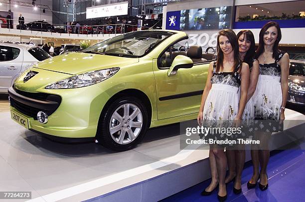 Models pose with the new Peugeot 207 CC at the 2007 Australian International Motor Show at the Sydney Convention and Exhibition Centre on October 11,...