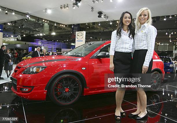 Models pose with the Mazda 3 MPS Extreme at the 2007 Australian International Motor Show at the Sydney Convention and Exhibition Centre on October...