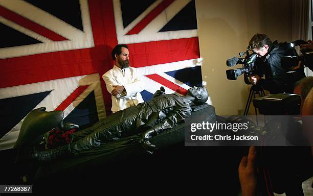 Artist Daniel Edwards stands next to his work of art entitled 'The Death of Prince Harry' by artist Daniel Edwards is on display at the Bridge Art...