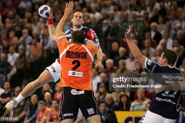 Pawel Orzlowski of Lubin is challenged by Thomas Morgensen of Flensburg during the Champions League group game between SG Flensburg-Handewitt and...