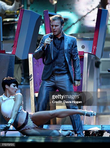 Take That's Gary Barlow performs on stage at Odyssey Arena at the start of their 'Beautiful World Tour' on October 11, 2007 in Belfast, Northern...