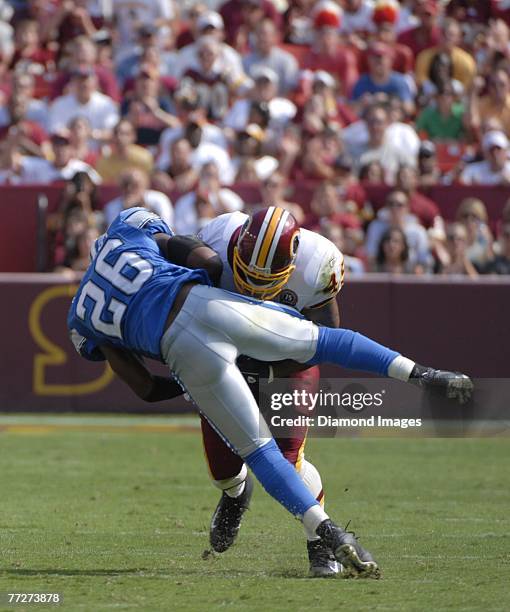 Runningback Mike Sellers of the Washington Redskins runs through the tackle attempt by safety Kenoy Kennedy of the Detroit Lions on a 24 yard pass...