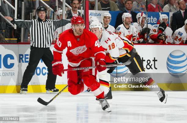 Henrik Zetterberg of the Detroit Red Wings heads back up ice in front of Wayne Primeau of the Calgary Flames in a game on October 10, 2007 at the Joe...