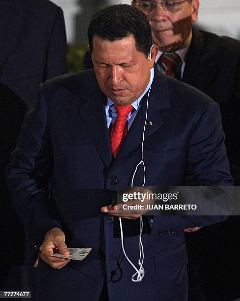 Venezuelan president Hugo Chavez listens to music in his ipod before the arrival of his Ecuadorian counterpart Rafael Correa, at the Miraflores...