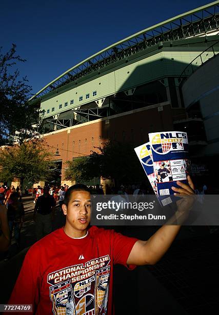 Vendor sells programs outside the stadium prior to Game One of the National League Championship Series between the Colorado Rockies and the Arizona...