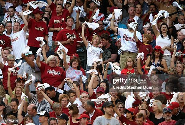 Fans of the Arizona Diamondbacks cheer before the start of Game One of the National League Championship Series against the Colorado Rockies at Chase...